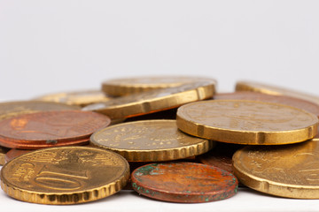 Pile of Euro coins isolated on white background. Selective focus