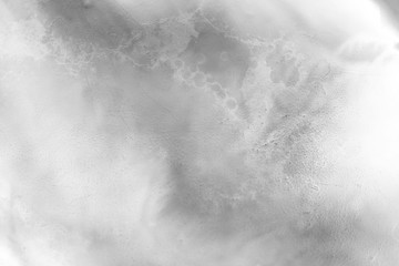 Gray alcohol ink texture with abstract washes and paint stains on the white paper background.