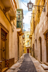 Beautiful typical narrow limestone street in Victoria, the capital of Gozo, Malta, streetscape...