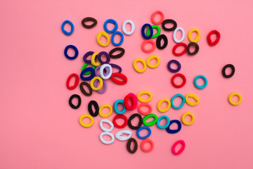 Photo with a lot of randomly lying multicolored hair elastics