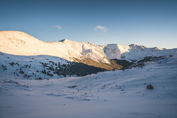 Fototapeta na wymiar Snowy Mountain Scene Near a Ski Resort at Sunset in the Beautiful Colorado Rocky Mountains