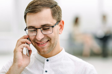 close up.smiling businessman talking on his smartphone