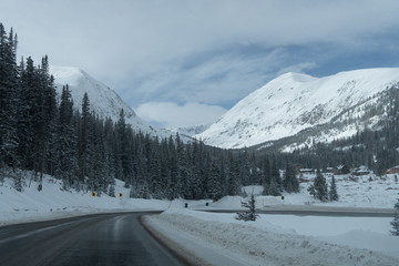 Fototapeta na wymiar Snowy Drive through the Mountain Peaks in the Colorado Rocky Mountains