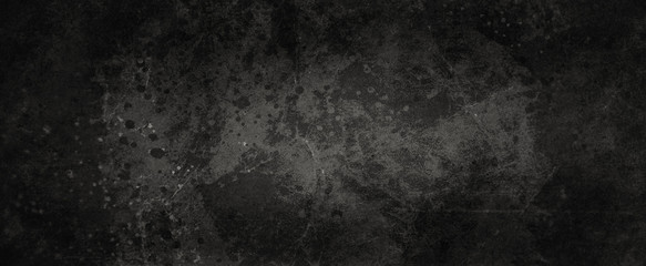 Old black grunge background texture with lots of grungy paint spatter and drips, messy marbled and cracked design elements in old vintage banner 