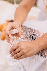 a glass of champagne in hand