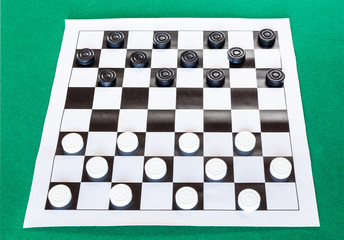 checkers on black and white checkered sheet board