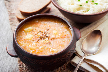 Kapustnyak - traditional ukrainian winter soup with sauerkraut, millet and meat