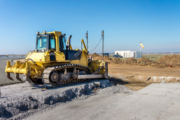 Construction site of road, building or airport with construction machinery (truck, bulldozer,...