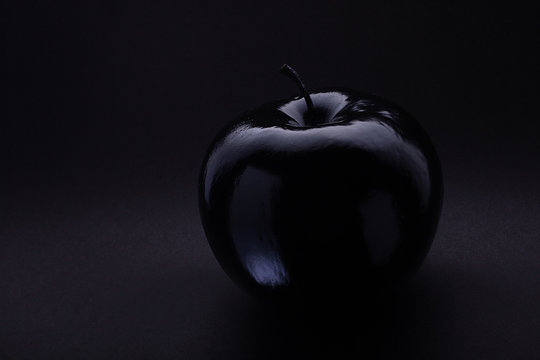Atmospheric monochrome Art black apple on a black background, black on black Concept Mystical, Magical, Fairy-tale