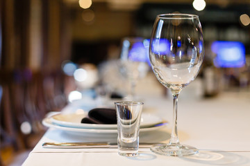 Empty vodka wine glasses on the banquet table
