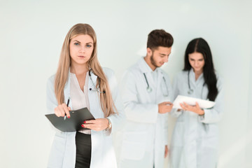 Fototapeta premium serious therapist with a clipboard while standing in clinic