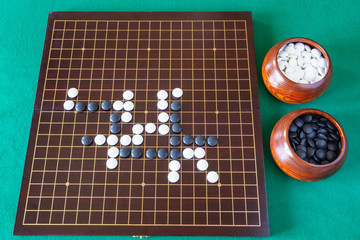 gameplay of Go game and playing stones in bowls