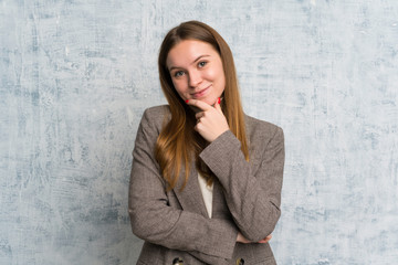 Young woman over grunge wall laughing