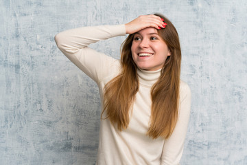 Young woman over grunge wall laughing