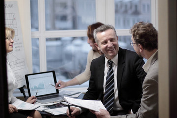 business partners engaged in dialogue in a modern office.