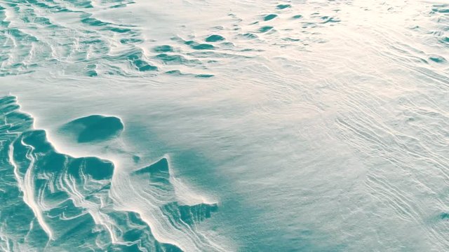 Beautiful snow winter bacground: arctic landscape at sunset, aerial view, space for text. Epic sunset above snow field. 