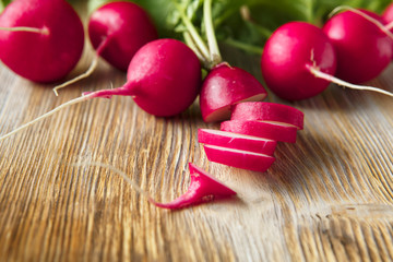 Freshly harvested, purple colorful radish on gray concrete background. Growing radish. Growing vegetables. Seasonal Cooking, food styling.