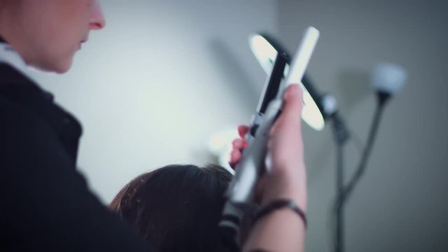 4k Model in Hair Studio, Hairdresser Using Hair Straightener