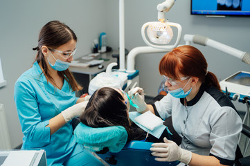 Fototapeta premium Dentist operating patient at surgery office