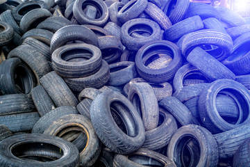 Pile of used rubber tyres background