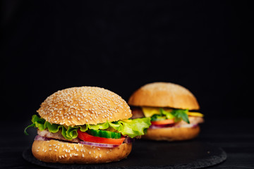 Tasty hamburger with fresh vegetables on the table