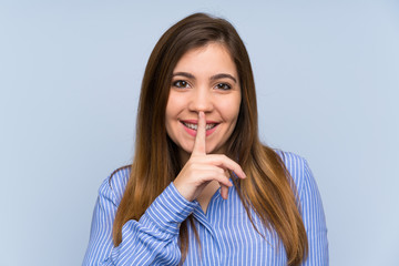 Young girl with striped shirt doing silence gesture