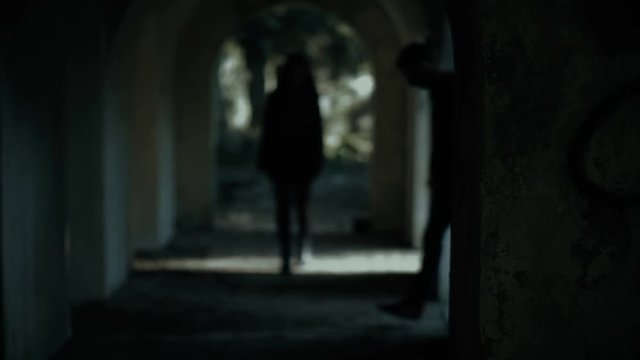 Woman walking alone  dark tunnel.Man attacking her.Violence against women,rape