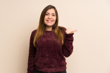 Young girl pointing to the side to present a product