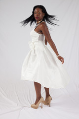 Pensive Black woman in white dress