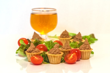 tartlets with liver pate decorated with lettuce and cherry tomatoes