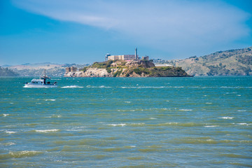 alcatraz prison during a summer day, view of the historic site of alcatraz in san francisco from the city pier during a summer day. united states