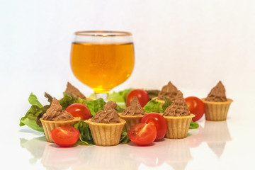 Obraz na płótnie Canvas tartlets with liver pate decorated with lettuce and cherry tomatoes