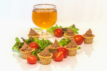 tartlets with liver pate decorated with lettuce and cherry tomatoes