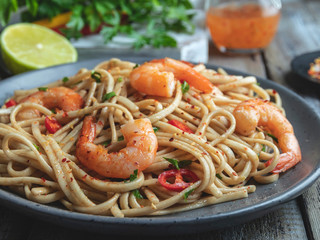  noodles  with shrimp , spice , on the plate. Closeup. Chinese/Japanese noodles