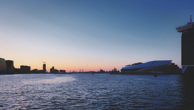 the river insude the harbour of amsterdam in sunset