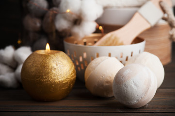 Spa products with golden candle and cotton