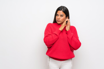 Young Colombian girl with red sweater scheming something