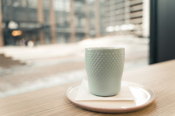 Coffee cup with window city view in morning
