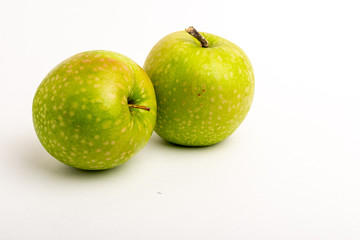 Two green ripe apple close up on a white background