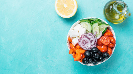 Greek Salad Bowl on blue background, copy space. Above view of Bowl Greek Salad. Trendy food. Idea, recept and concept of modern healthy food. Banner