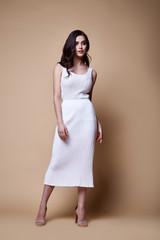 Sexy beauty woman pretty face tan skin wear knitted blouse skirt long skinny body shape makeup...