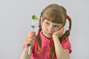 little girl does not want to eat broccoli - obrazy, fototapety, plakaty