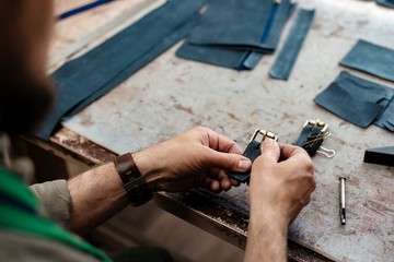 A master works with genuine leather making exclusive things