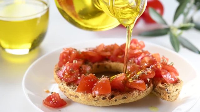 Apulian traditional summer dish. Eat with Tomatoes, Olive Oil and Origano. Italian starter friselle. Classical frisella with tomato, salt, oregano and olive oil. Tipical apulian still-life of healthy 