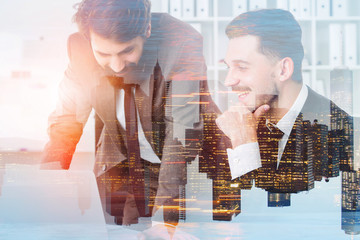 Two smiling managers in office