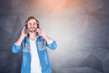 Casual man listening to music, gray background