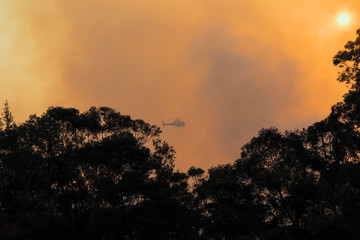 Helicopter operation in an organised Fire Service back burning to prevent bush fires in the mountains.