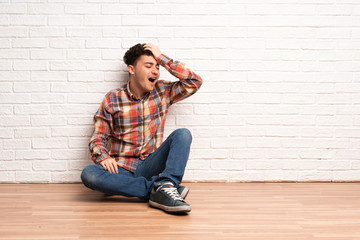 Young man sitting on the floor has realized something and intending the solution