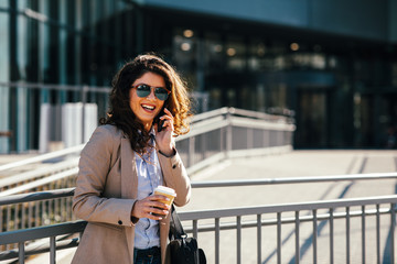 Young business woman talking on the phone in the city