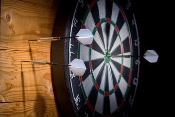 one dart in target two darts miss. 